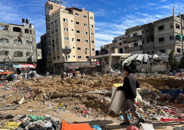 Palestinians inspect damages following an Israeli raid at Kamal Adwan hospital