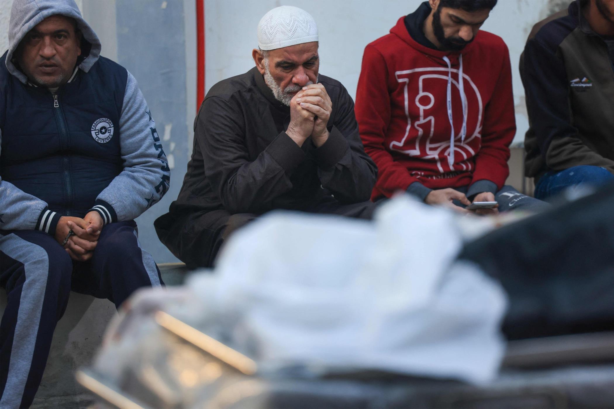 Relatives mourn next to the shrouded body of a person killed during Israeli bombardment in Rafah, southern Gaza Strip, Palestine, Dec. 11, 2023. (AFP Photo)